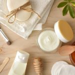 Cosmetics with honey extracts with tools and toiletries on wooden table. Horizontal composition. Top view.